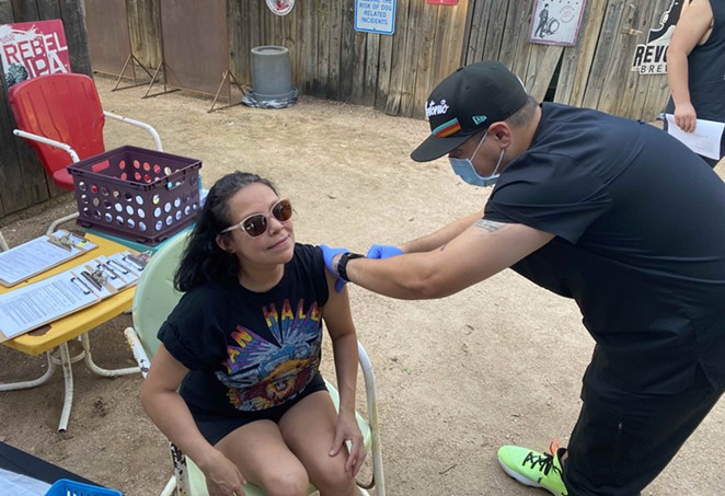 Mel Ramos gets vaccinated at The Friendly Spot’s ‘beer and a shot’ pop-up clinic. - SANFORD NOWLIN