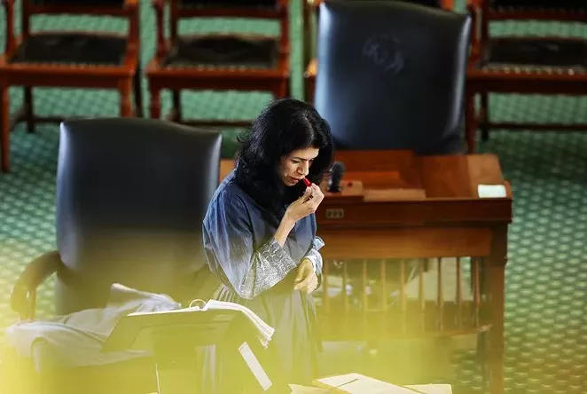 State Sen. Carol Alvarado, D-Houston, applies lipstick in her 15th hour of filibustering against Senate Bill 1. - TEXAS TRIBUNE / MIGUEL GUTIERREZ JR.