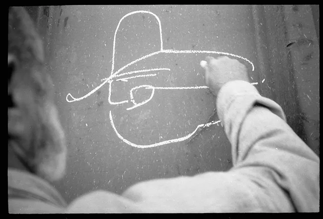 Russell Butler's "Colossus of Roads" image features a simple line-drawing profile of a trainman wearing a cowboy hat. - BILL DANIEL