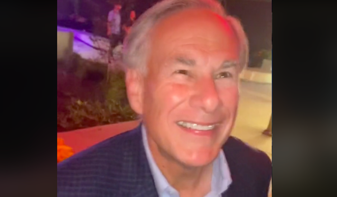 Gov. Greg Abbott grins and bears it while getting called a "douchebag." - TIKTOK SCREEN CAPTURE / @ERICKATZENBERGER