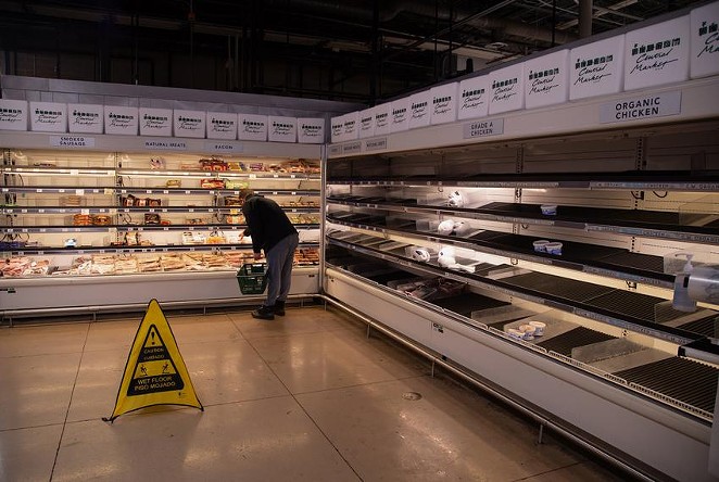 A customer looks through nearly empty shelves inside a Central Market grocery store in Austin on Feb. 17, 2021. - TEXAS TRIBUNE / EVAN L'ROY
