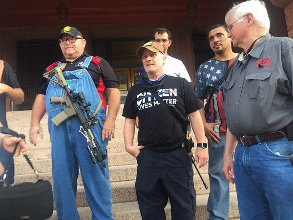 CJ Grisham (center), president of Open Carry Texas, says McDonnell should be commended, not prosecuted. - MICHAEL BARAJAS