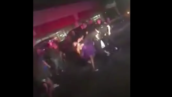 In the grainy video, the girl's head can be seen reeling back after an officer extends his arm - SCREENSHOT