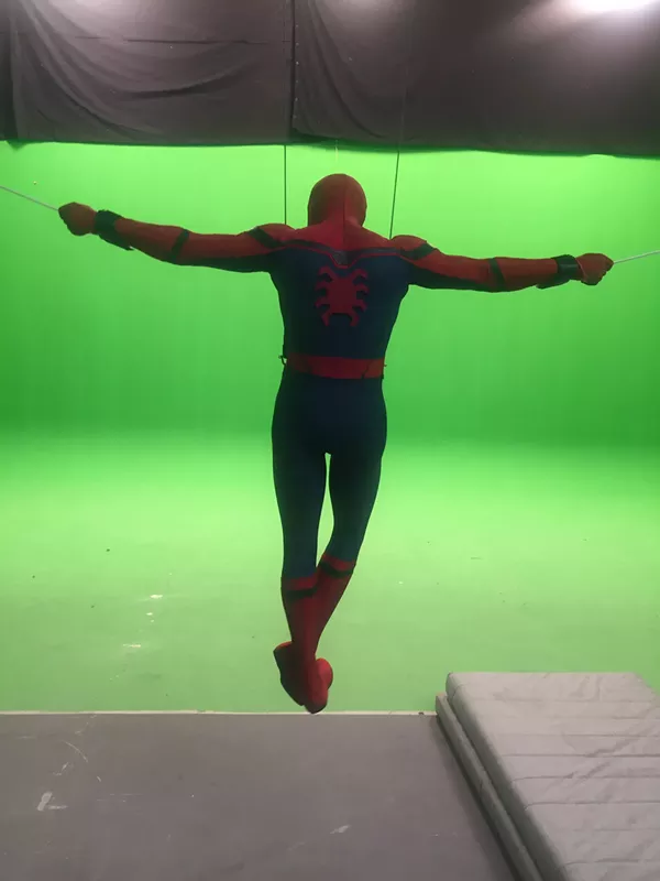 Chris Silcox in full Spider-Man outfit doing stunts on a green screen. - CHRIS SILCOX