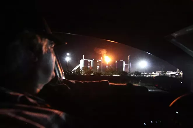 Mike Cerny surveys an oil storage site across the street from his Karnes County home in 2013 - MICHAEL BARAJAS