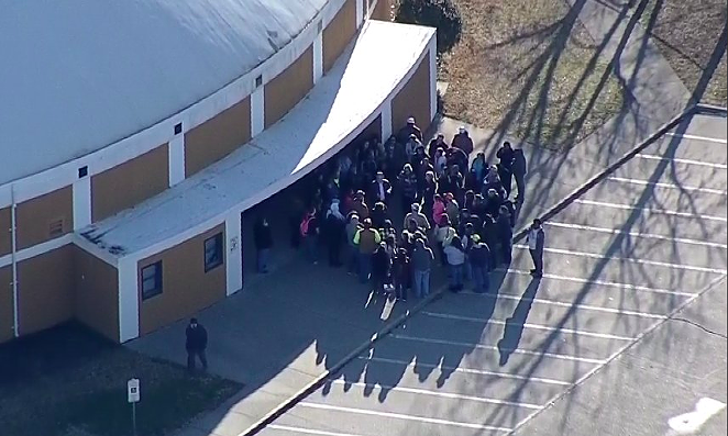 Parents gather outside of an Italy High School building Monday morning. - TWITTER / @GRLOPEZ4