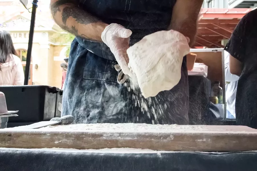 Grimes adds flour to the dough before it has been proofed. - LEA THOMPSON