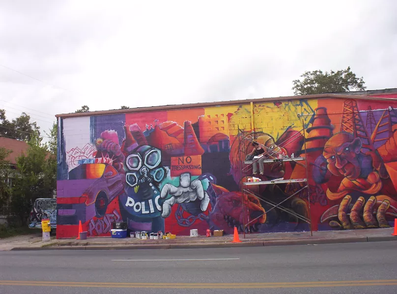 Muralist Ruth Buentello works on "Piedad" in 2003. - COURTESTY
