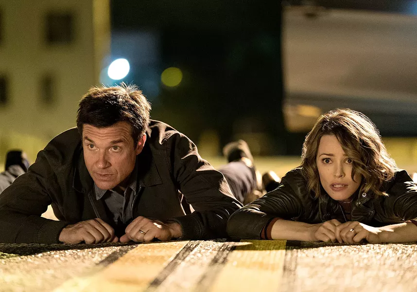 Married couple Annie and Max (Rachel McAdams and Jason Bateman) get in over their heads during the R-rated comedy Game Night. - WARNER BROS.