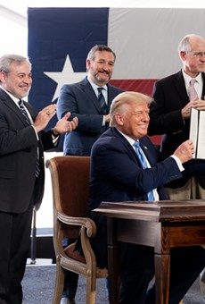 Donald Trump shows off his signature on federal permits during an appearance in Midland this summer.