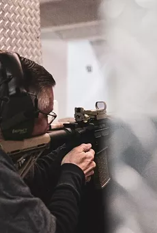 Rep. Tucker Sprayberry, R-Sanderson, demonstrates how his voting bill would work by blasting a hole through a sample ballot.