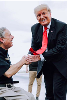 Gov. Greg Abbott (left) shakes hands with former President Donald Trump during a border photo op in late June.