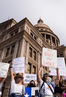 Protesters stand at the front steps of the state Capitol in opposition to Texas' abortion restrictions law on Oct. 2, 2021.