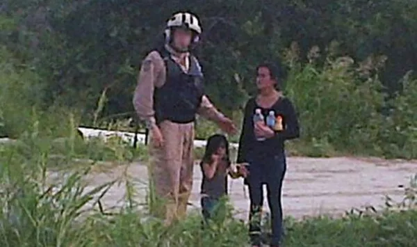 This 2014 photo shows a dehydrated teenage girl accompanied by a little girl who Border Patrol rescued in the Rio Grande Valley. Both were likely turned over to Immigration and Customs Enforcement. - U.S. BORDER PATROL