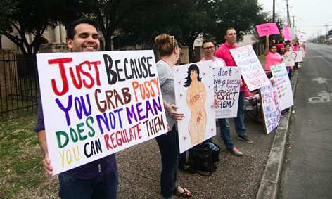 Planned Parenthood supporters hold signs at a San Antonio rally in 2017. - MICHAEL BARAJAS