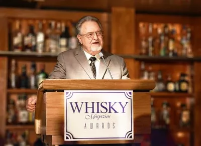 Master Distiller Emeritus Willie Pratt accepts his induction to The Whisky Magazine Hall of Fame in 2017. - COURTESY MICHTER'S