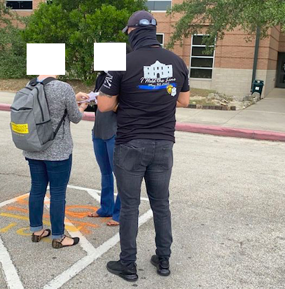 This photo shared by police accountability activists purports to show a man harassing a petition volunteer. The man's shirt features images of a badge and an SAPD logo along with the slogan of This Is Texas Freedom Force, which has been labeled an extremist group by the FBI, the activists maintain. - COURTESY PHOTO / SAN ANTONIO COALITION FOR POLICE ACCOUNTABILITY