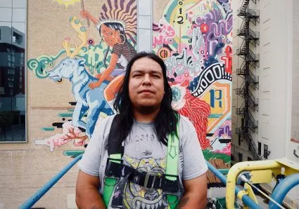 Rudy Herrera stands in front of “The Last Parade” recently. - COURTESY PHOTO / RUDY HERRERA