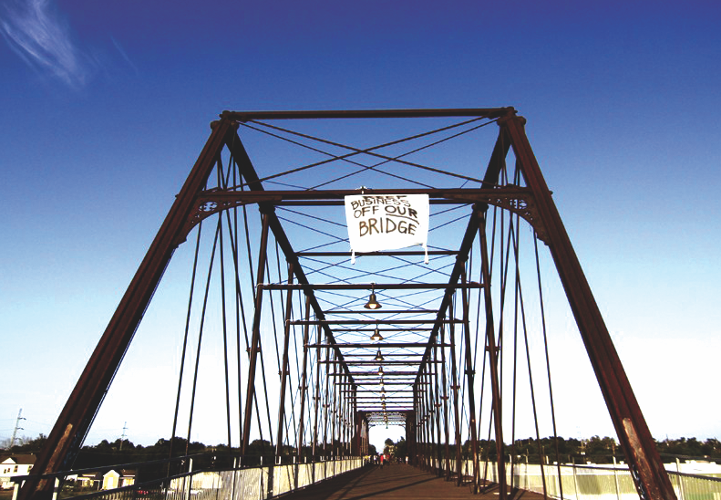 Activists hung a banner from the bridge in 2012 to protest the construction of the Alamo brewery. - MICHAEL BARAJAS