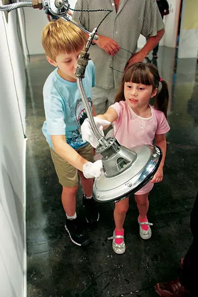 Young visitors play at 'Interplay: Mechanical Objects.' - COURTESY PHOTO