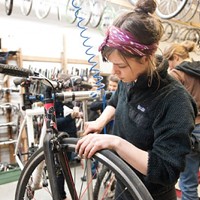 Bike Collective volunteer Tara Christensen tinkers during Women’s Night