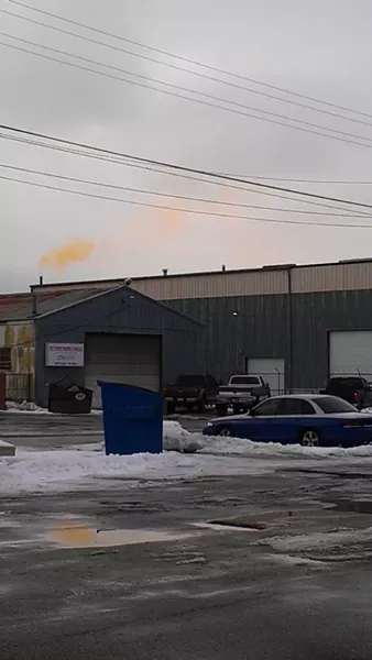 Neighbors of Accurate Recycling in Murray say the plume of smoke emitted by the business (in background of photo) made them sick