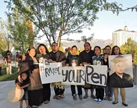 Raise Your Pen Coalition members at a vigil at the federal courthouse