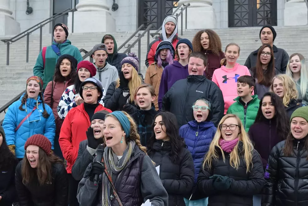 Holly Lammert, front, a teacher from Realms of Inquiry, leads a chant in support of public lands outside the Capitol on Thursday - RAY HOWZE