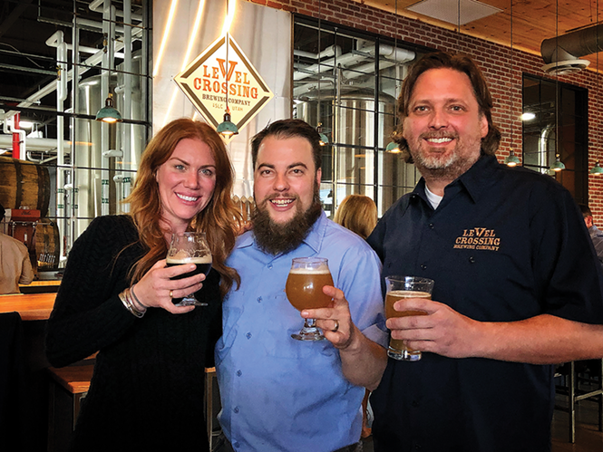 The Level Crossing Brewing Co. braintrust: Business development manager Katie Flanagan, left, head brewer Chris Detrick, middle, and owner Mark Medura - MIKE RIEDEL