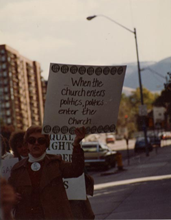 Demonstrators carrying pro-ERA signs march down SLC streets on Oct. 2 1982, during The Church of Jesus Christ of Latter-day Saints' General Conference. - NATIONAL ORGANIZATION FOR WOMEN PHOTOGRAPHY COLLECTION