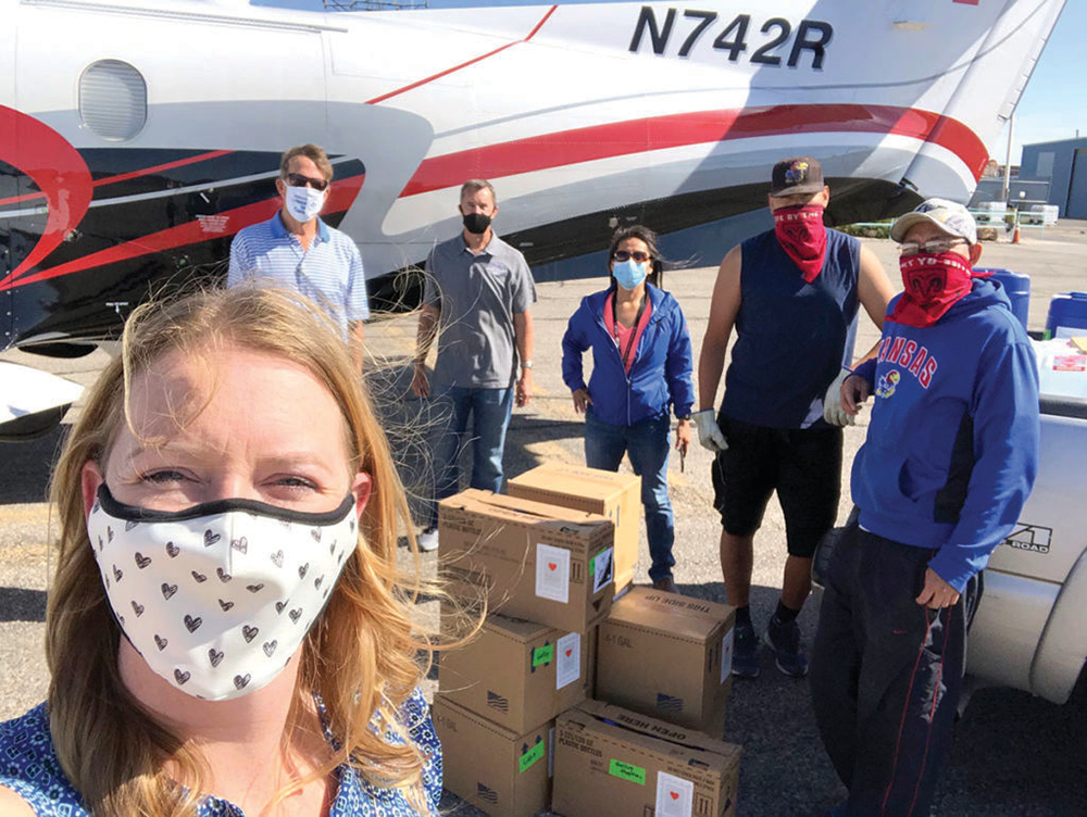 Dr. Thuet, front left, founder of With Love, From Strangers, and her crew load PPE headed to Southwest tribal communities.