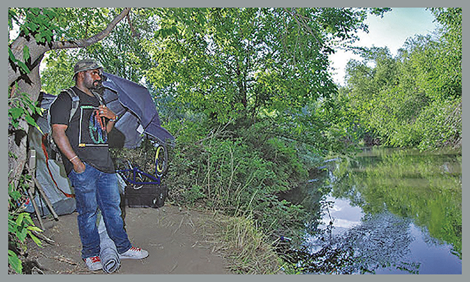 Marvin Stevens’ campsite, hidden behind a state administration building. Stevens has experienced homelessness since the Great Recession. - BEN DESOTO