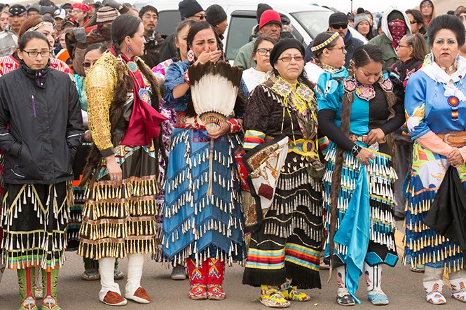 A group of women align to do a traditional dance the day after authorities cleared the front line camp. - WESTON BURY