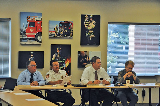 Former UFA Fire Chief Michael Jensen (center) at a July 19, 2016, closed-session meeting, during which the board accepted Deputy Chief Gaylord Scott’s resignation. - COLBY FRAZIER