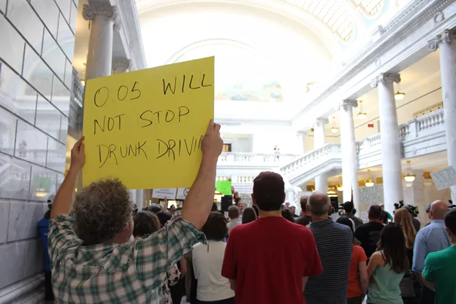 A Protester holds up an anti-HB155 sign last Friday at the Capitol. - ENRIQUE LIMÓN