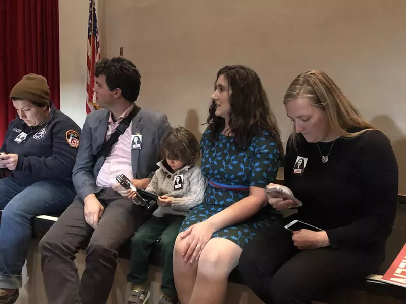 Accompanied by her husband Nicholas Steffens and son Desmond, Ghorbani awaits her fate during a recent meeting of the Salt Lake County Democratic Central Committee. - KELAN LYONS