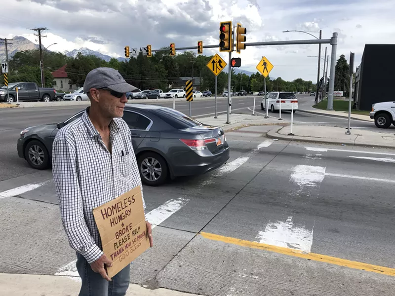 As he stands with his sign on 700 East, Martin says he understands the new laws regarding roadside panhandling and tries to stay out of trouble. - KELAN LYONS