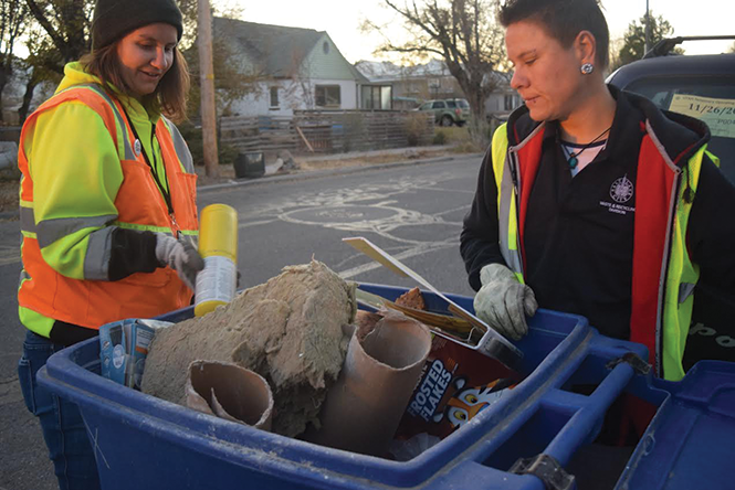 Ashley Bailey, left, and Kellie Ulrich inspect recycling bins in the Glendale neighborhood for misplaced items. - RAY HOWZE