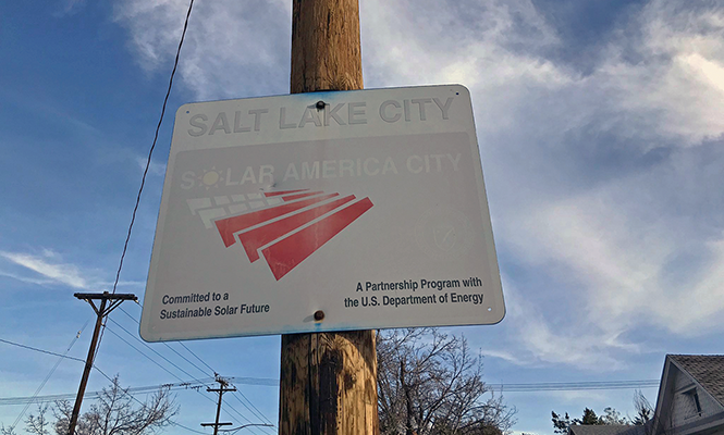 A sun-faded sign on 1300 East boasts Salt Lake City’s status as a “Solar America City” committed to a sustainable future. - BRYANT HEATH