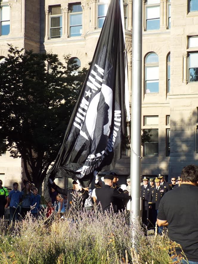 Army officials raise the MIA/POW flag at the Salt Lake City and County building. - BEN MARTINEZ