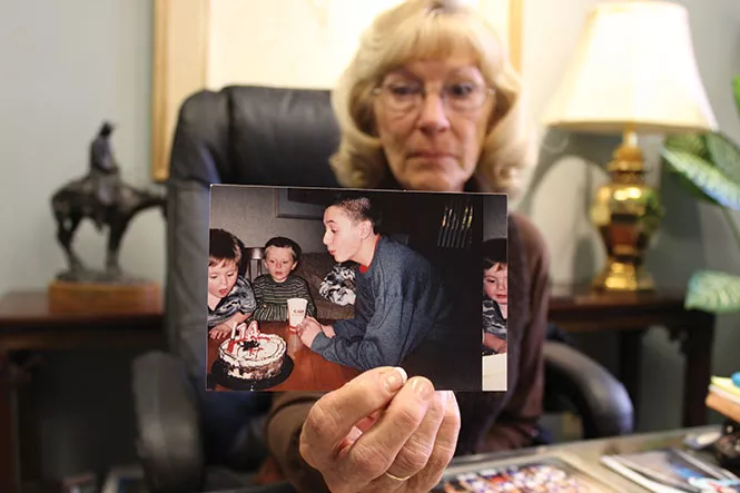 Brock Tucker’s grandmother, Janet Crane, holds up a memento depicting happier times on Monday, Oct. 10. - ENRIQUE LIMÓN