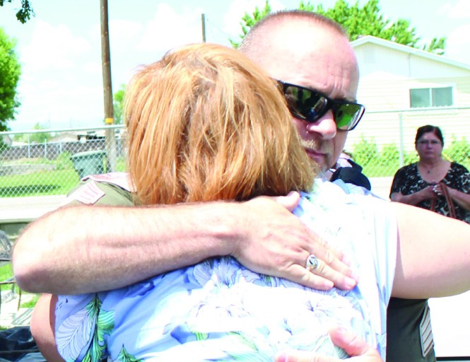 Detective David Brewer gives Heidi Jones-Asay a hug just before the body of her mother is reinterred at the Elmo Cemetery in Emery County.