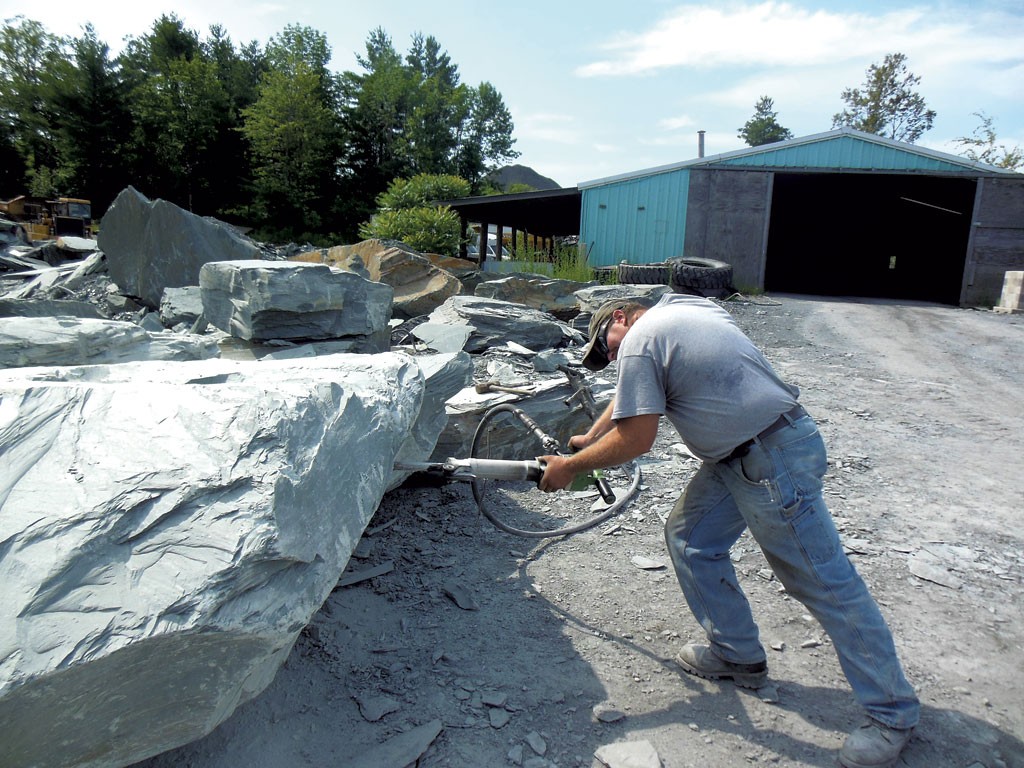 A Camara company worker jackhammering a block of slate at the Blissville quarry. - KEVIN J. KELLEY