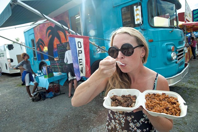 Andrea Haney enjoying jerk chicken and rice and peas at the Champlain Valley Fair - MATTHEW THORSEN