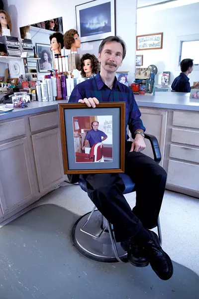 Bernie Dubois holds a photo of his father, Camile Dubois - MATTHEW THORSEN