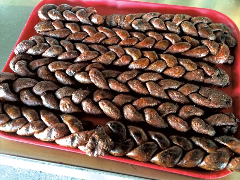 Braided merguez waiting to be smoked - ALICE LEVITT