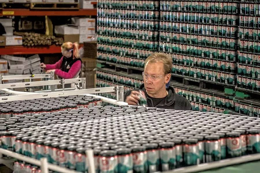 Brewmaster Dave Hartmann among the cans - PHOTOS COURTESY OF LONG TRAIL BREWING CO.