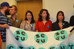 Burlington College students hold a banner at Tuesday's press conference. - ALICIA FREESE