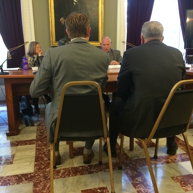 CCA officials from left, Daniel Kaman and Kevin Myers, talk to Sen. Dick Sears (D-Bennington) during a Joint Legislative Corrections Oversight Committee meeting. - MARK DAVIS