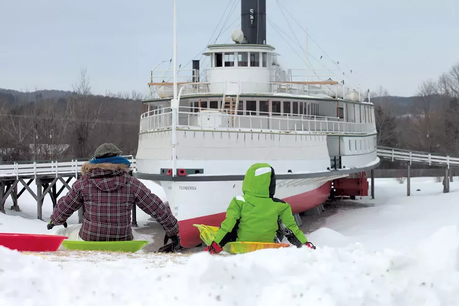 Children sledding on the hill near the Ticonderoga - MATTHEW THORSEN